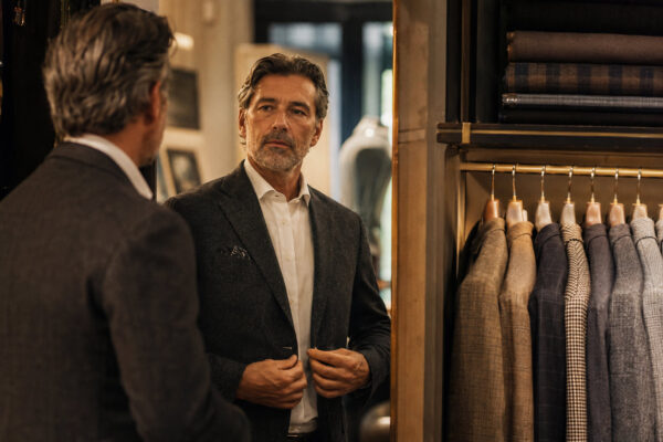 man checking outfit in mirror