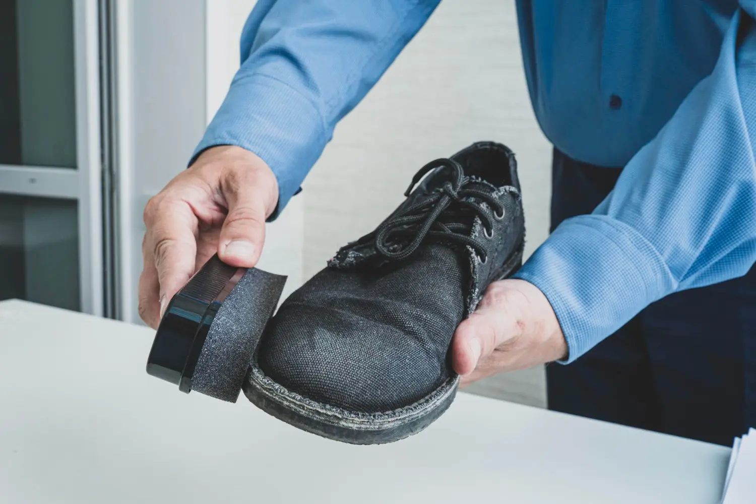 man-wipes-shoes-with-special-soaked-sponge-cleaning-dance-shoes