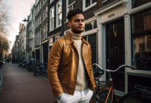 20 year old guy standing on the street with hands in his trouser pockets