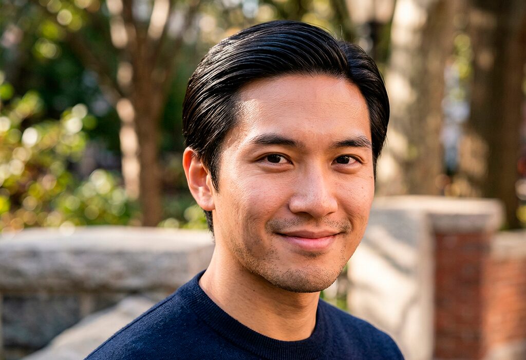 Man with sleek low porosity hair outdoors showing smooth shine and healthy defined texture