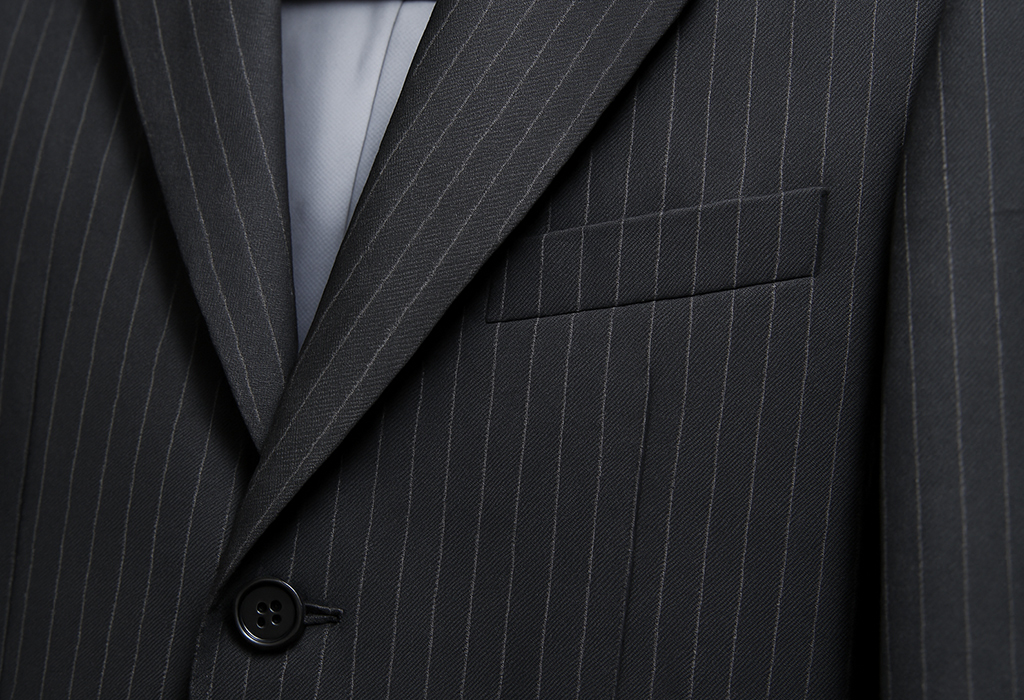 Close up Image of a charcoal gray pinstripe suit