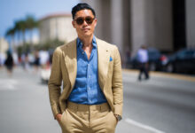 man wearing a medium blue chambray shirt with a tan linen suit