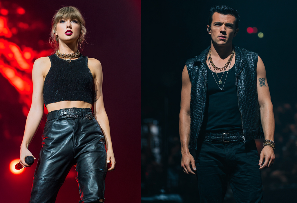 Taylor Swift wears black leather and chains; the man matches with a black vest and bold jewelry.