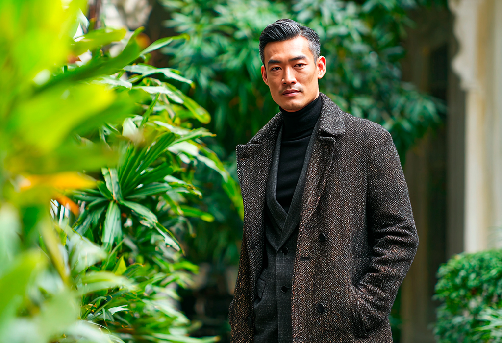 old money autumn style - herringbone topcoat over black turtleneck and suit