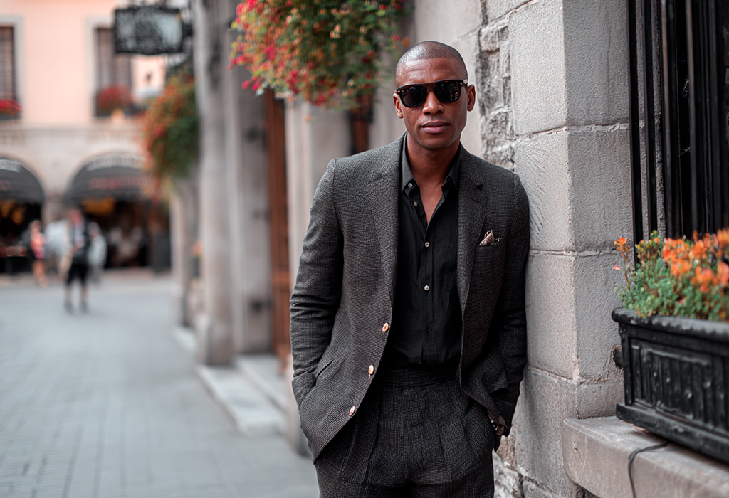 Stylish man wearing dark suit and sunglasses