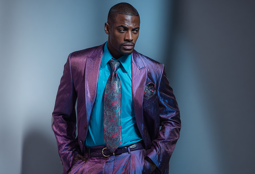 Man wearing oversized shiny purple suit, outdated style