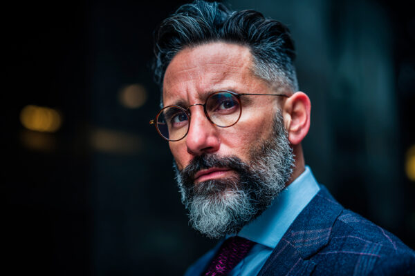 man in glasses and suit wearing beard