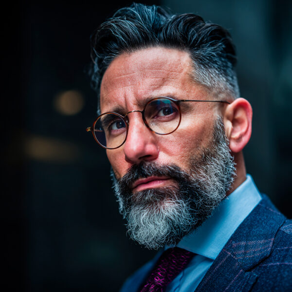man in glasses and suit wearing beard