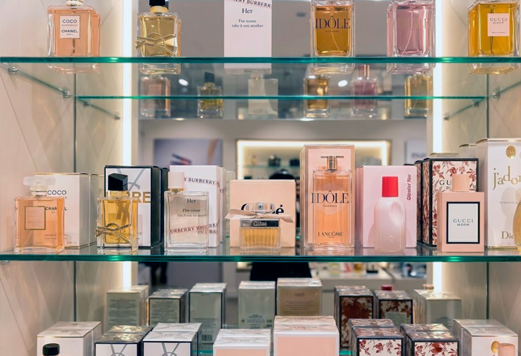 Display shelf with designer women’s fragrances like Chanel, Dior, YSL, Burberry, and Gucci