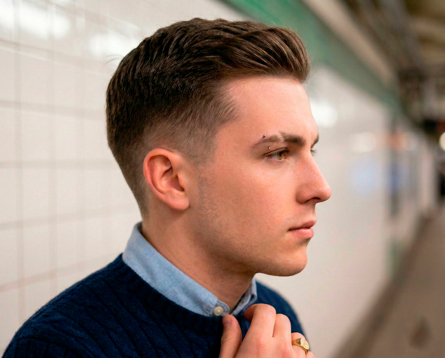 Man with classic Ivy League haircut styled with neat side part and tapered sides.