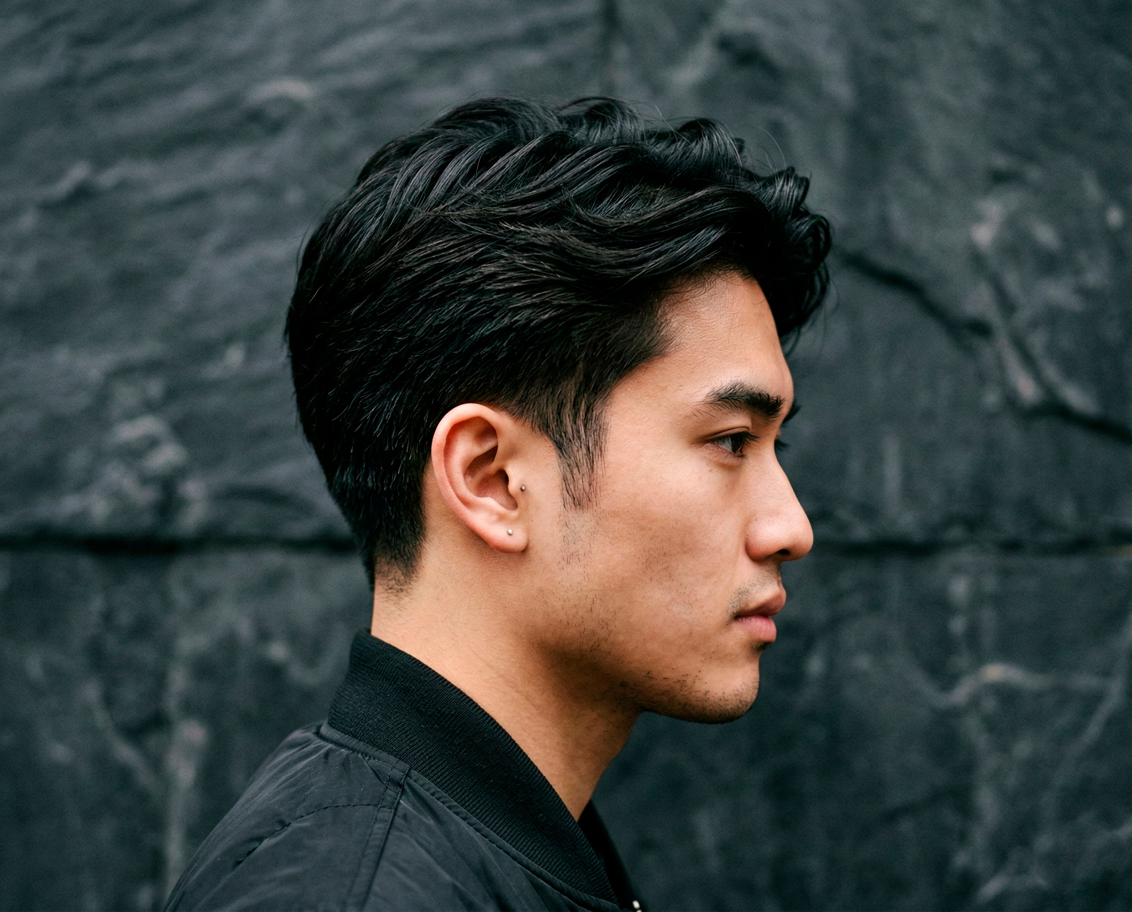 Man with scissor taper haircut featuring natural texture on top and gradual tapered sides.