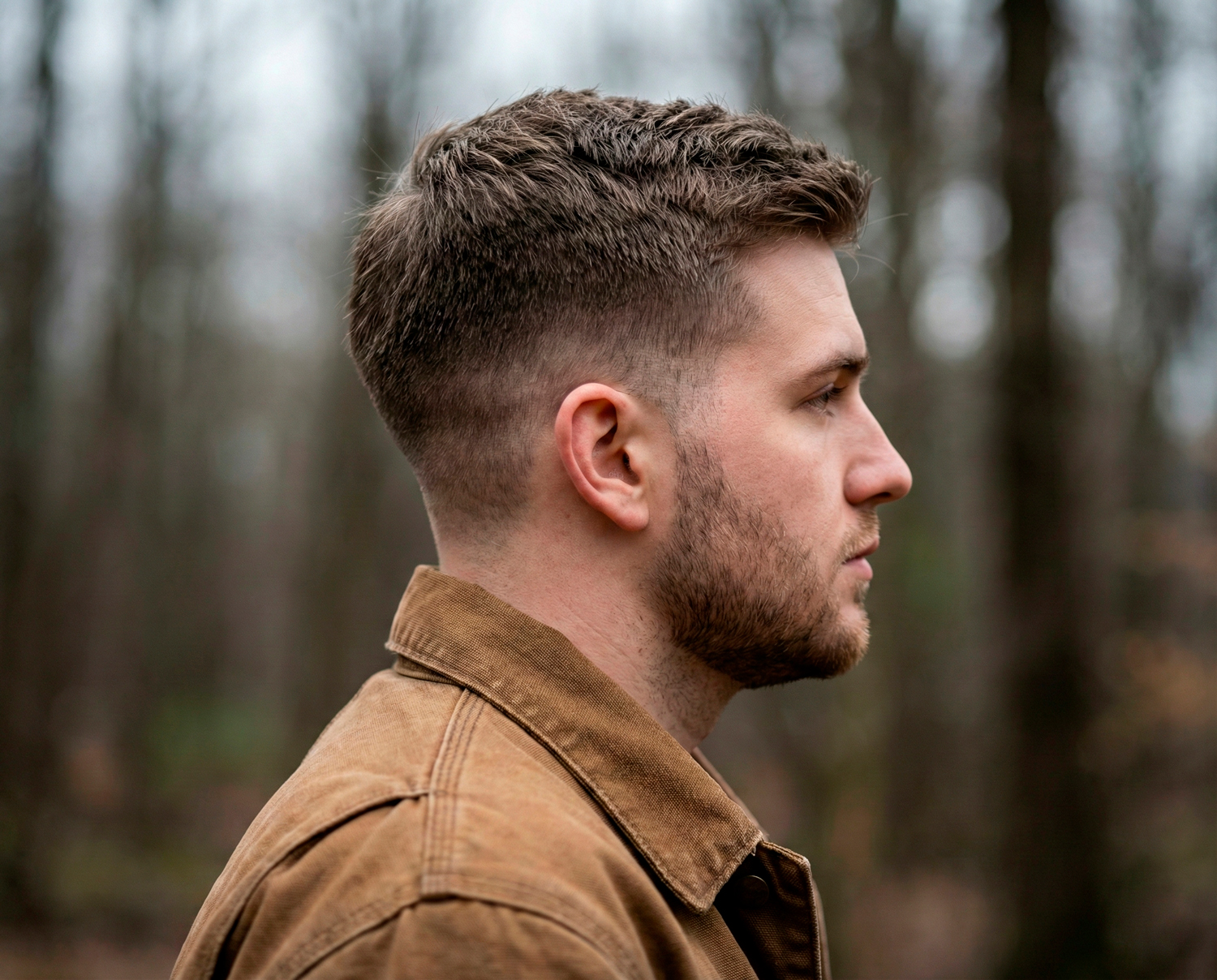 Man with classic short back and sides haircut with clean fade and neat masculine profile.