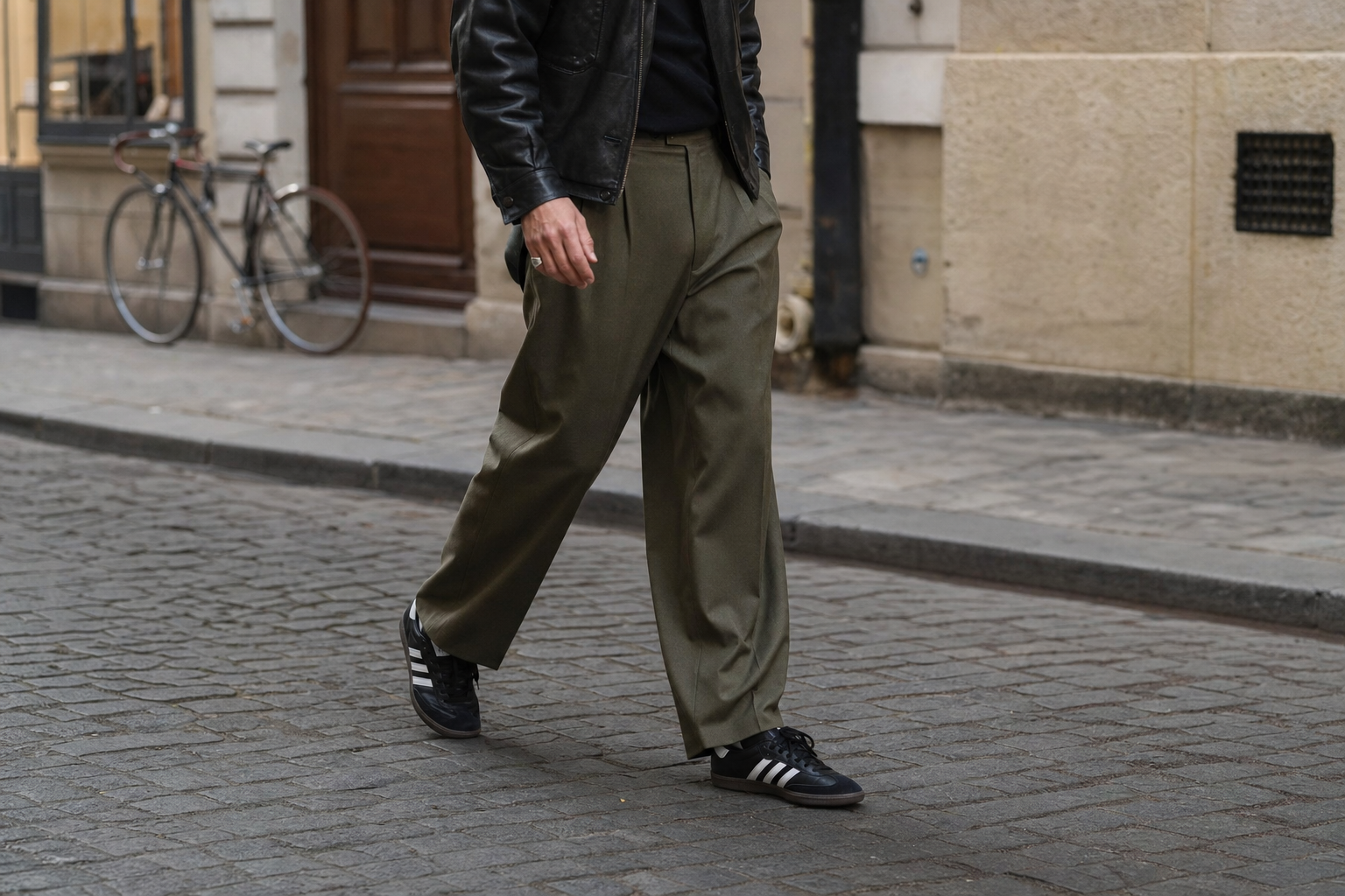 man walking in wide leg trousers and adidas samba sneakers